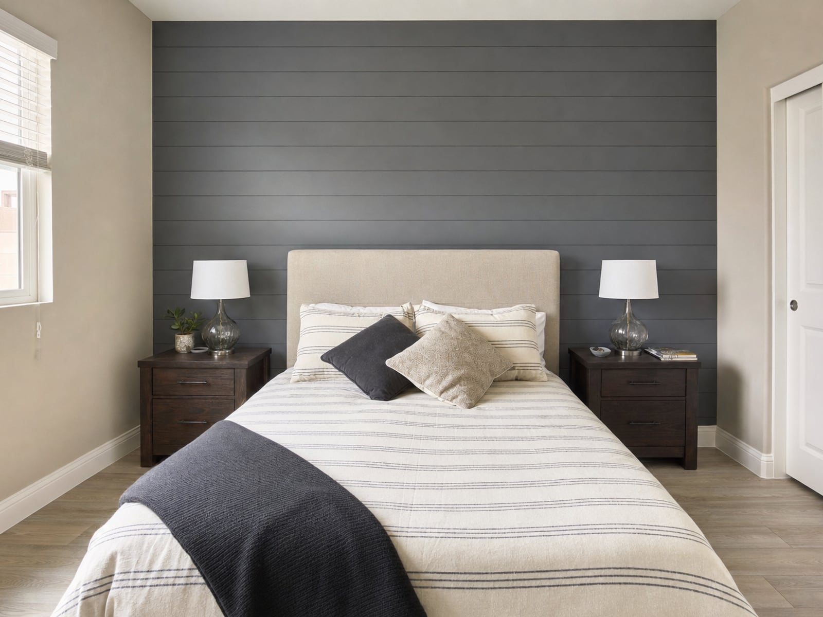 Shiplap Accent Wall: Charcoal shiplap behind the bed